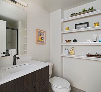 Bathrooms include walk-in showers with glass doors and custom vanities