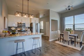 Sun Prairie apartment for rent - an open kitchen and dining room with a table and chairs