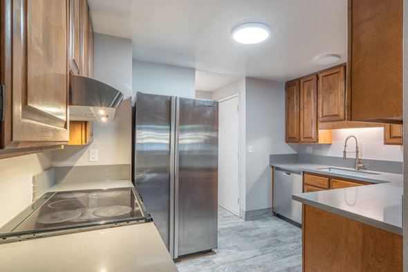 Portland apartment for rent - a kitchen with stainless steel appliances and wooden cabinets