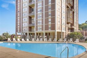 East Cleveland apartment for rent - a swimming pool in front of an apartment building