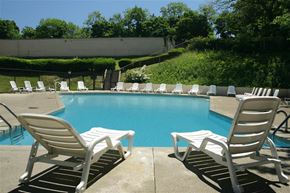 East Cleveland apartment for rent - a pool with rocking chairs and chairs around it