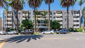Los Angeles apartment for rent - a street view of an apartment building with cars parked in front
