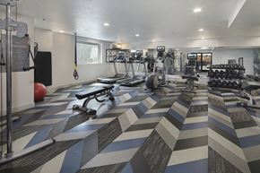 Los Angeles apartment for rent - a gym with cardio machines and weights on the floor