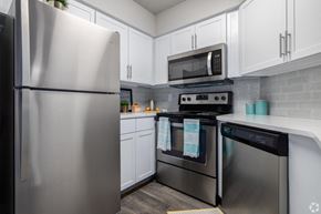 Ponte Vedra Beach apartment for rent - A kitchen with a stainless steel refrigerator and a microwave above the stove.