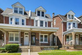 Philadelphia apartment for rent - the front of a brick house with a white porch