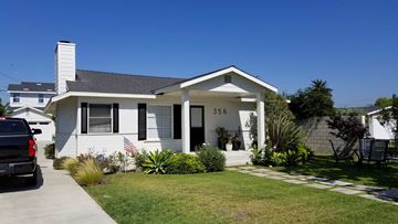 Costa Mesa apartment for rent - A white house with a black car parked in front.