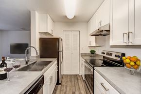 Lexington Park apartment for rent - a kitchen with stainless steel appliances and white cabinets