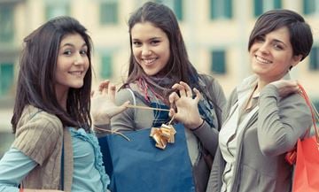 West New York apartment for rent - Three women are standing together, each holding a shopping bag.