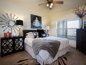 Grandview apartment for rent - a bedroom with a large bed and a ceiling fan