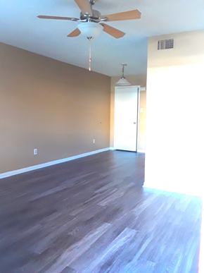 San Antonio apartment for rent - an empty living room with wood floors and a ceiling fan