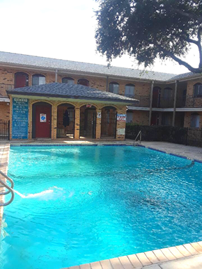 San Antonio apartment for rent - a large swimming pool in front of a building