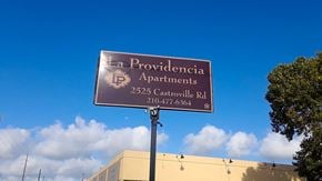 San Antonio apartment for rent - a sign for the providence apartments in front of a blue sky