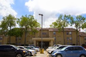 San Antonio apartment for rent - an office building with a parking lot full of cars