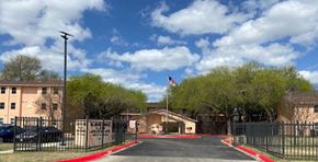 San Antonio apartment for rent - a house with a fence and an flag