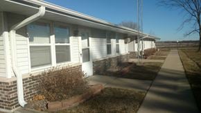Thomson apartment for rent - the front of a white house with a sidewalk in front of it