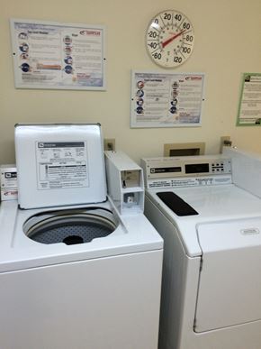 Galena apartment for rent - a laundry room with two washing machines and a clock on the wall