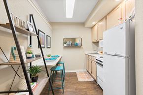 Metairie apartment for rent - A kitchen with a white refrigerator and a wooden floor.
