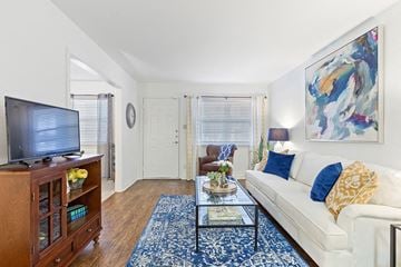 Metairie apartment for rent - a living room with a white couch and a television