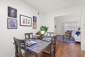 Metairie apartment for rent - a dining room with a wooden table and chairs