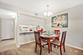 Metairie apartment for rent - A dining room with a table set for four.