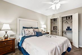 Metairie apartment for rent - A bedroom with a large bed and a ceiling fan.