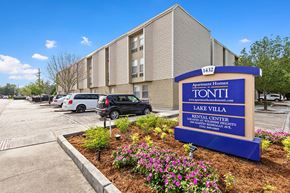 Metairie apartment for rent - A sign for Tonti Lake Villa Apartment Homes is in front of a building.