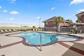 Metairie apartment for rent - A round pool with a brown and tan border.
