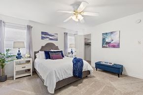 Metairie apartment for rent - A bedroom with a large bed and a ceiling fan.