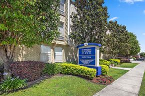 Metairie apartment for rent - A sign for Tonti Patio Villa is in front of a building.