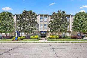 Metairie apartment for rent - A building with a blue sign in front of it.