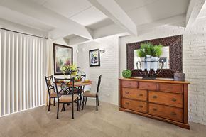 Metairie apartment for rent - A dining room with a table set for two and a plant on the dresser.