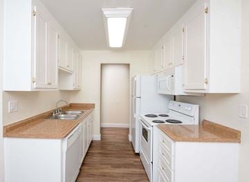 San Lorenzo apartment for rent - A kitchen with white cabinets and a brown counter top.