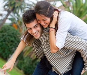 Fort Lee apartment for rent - A man is carrying a woman on his back in a park.