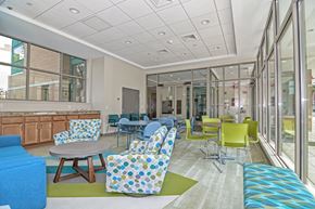 Boston apartment for rent - a lobby with colorful chairs and tables and windows
