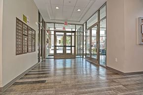 Boston apartment for rent - a hallway in a building with glass doors and bulletin boards