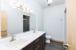 Sioux City apartment for rent - a bathroom with a large mirror and a sink and a toilet