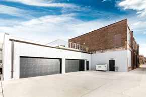 Sioux City apartment for rent - the side of a building with a garage door and a balcony
