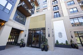 Edina apartment for rent - a building with a large entrance to a hotel with potted plants