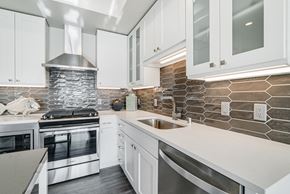 Edina apartment for rent - a kitchen with white cabinets and stainless steel appliances