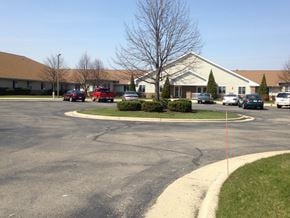 Delavan apartment for rent - a parking lot with cars in front of a house
