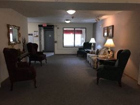 Kiel apartment for rent - A living room with a couch, chair, and lamp.