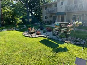 Edgerton apartment for rent - a yard with a sign in front of a house