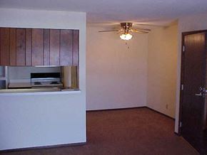Marshall apartment for rent - an empty living room with a ceiling fan and a microwave