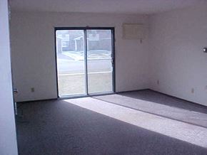 Marshall apartment for rent - an empty living room with a sliding glass door