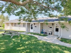St. Nazianz apartment for rent - a small white house with a picnic table in the yard