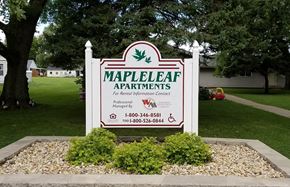 Wataga apartment for rent - a sign for maple leaf apartments in front of a yard