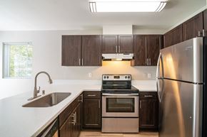 Bothell apartment for rent - a kitchen with wooden cabinets and stainless steel appliances