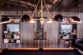 Chicago apartment for rent - a pool table and lights in a room with wooden walls