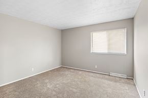 Indianapolis apartment for rent - an empty bedroom with a window and carpeting