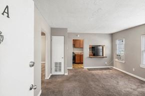Indianapolis apartment for rent - an empty living room with a tv and a kitchen